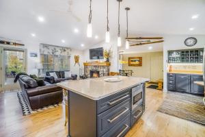 a kitchen with a large island in a living room at Red Pine Retreat in Thompsonville +20 photos