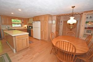 a kitchen and dining room with a wooden table and chairs at Thorogood Glen in Empire