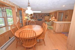 a kitchen and dining room with a wooden table and chairs at Thorogood Glen in Empire
