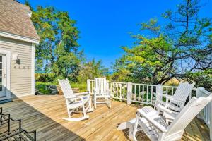 three white rocking chairs on a wooden deck at Blue Bear in Glen Arbor