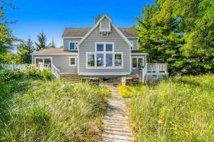 a house on a hill with a pathway leading to it at Blue Bear in Glen Arbor