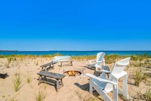 a group of chairs and a fire pit on the beach at Blue Bear in Glen Arbor