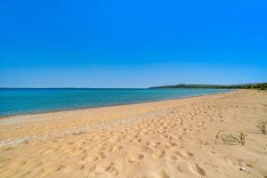 a sandy beach with the ocean in the background at Blue Bear in Glen Arbor