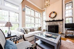a living room with a couch and a fireplace at Azure Forest Pool House in Union Pier