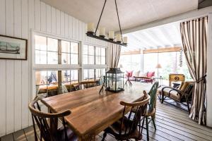 a dining room with a wooden table and chairs at Azure Forest Pool House in Union Pier
