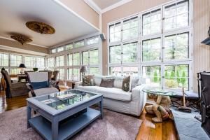 a living room with a couch and a table at Azure Forest Pool House in Union Pier