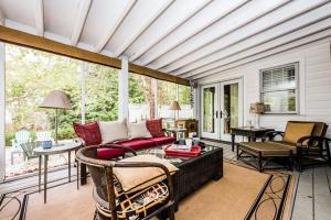 a living room with a couch and a table at Azure Forest Pool House in Union Pier +22 photos