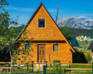 a small wooden house with a pointed roof at Bugen Villa II in Žabljak