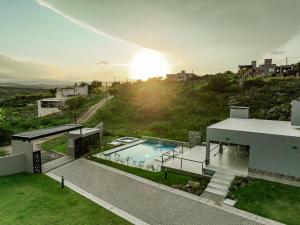 a view of a house with a swimming pool at Sunset Village in Villa Carlos Paz