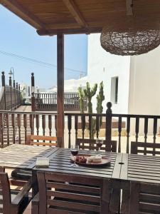 a wooden table with a plate of food on a patio at Casa Lava in Punta Mujeres
