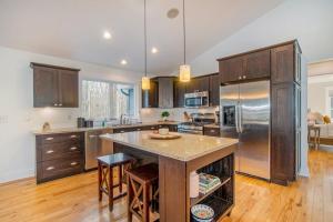 a kitchen with a large island in a kitchen with wooden floors at Borrowed Thyme in Saugatuck