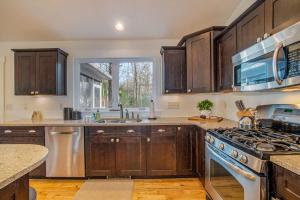 a kitchen with wooden cabinets and a stove top oven at Borrowed Thyme in Saugatuck +25 photos
