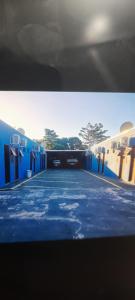 a view of a car garage with blue at Hotel Centro Sul in Anastácio