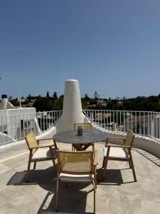 a table and chairs on top of a roof at Villa Valentina-Sunny 2 Bedroom House with Pool in Carvoeiro +50 photos