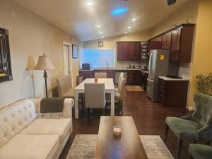 a living room with a couch and a table and a kitchen at Urban Retreat -Suite A in San Jose