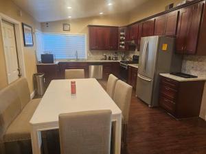 a kitchen with a table and a refrigerator at Urban Retreat -Suite A in San Jose +5 photos