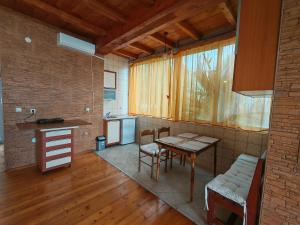a kitchen and dining room with a table and chairs at Lana Seafront Apartments in Šušanj