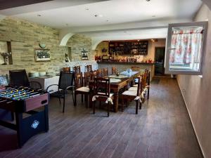 a restaurant with a table and chairs and a bar at Villa Mare Apartments in Tivat