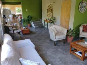 a living room with a couch and chairs and a table at Cabaña con costa de arroyo in San Martín de los Andes +25 photos