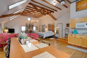 a large living room with a table and a kitchen at Pet-Friendly Loft Vacation Rental w/ Fire Pit! in Bemus Point