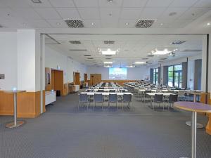 a large room with tables and chairs in it at Novotel München City in Munich +226 photos