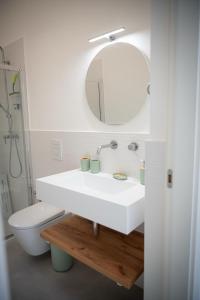 a bathroom with a white sink and a mirror at Le Cromie di Amelie in Ceglie Messapica +57 photos