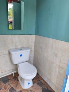 a bathroom with a toilet and a mirror at Casa Finca la Casona con Piscina Privada - Cerca al Parque Tayrona in Santa Marta +17 photos