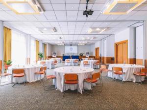 a banquet hall with white tables and chairs at Novotel Venezia Mestre Castellana in Mestre +172 photos