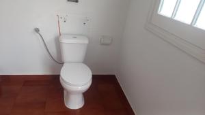 a white toilet in a bathroom with a window at Casa Pascoal in Ribeira Grande +16 photos