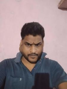 ein Mann mit blauem Hemd und Schnurrbart in der Unterkunft Tranquiline in Dhanbad