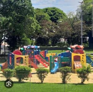 a playground in a park with a colorful slide at Casa da Serra in Serra Negra
