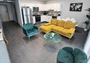 a living room with a couch and a table at Golden Fern Escape in Des Moines
