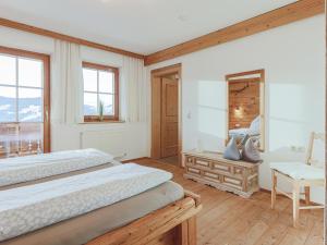 a bedroom with two beds and a mirror at Igl Hof Top 2 in Westendorf