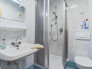 a bathroom with a shower and a sink and a toilet at Igl Hof Top 2 in Westendorf +22 photos