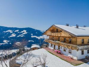 a large wooden house with snow on the roof at Igl Hof Top 3 in Westendorf