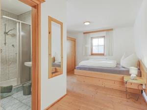 a bedroom with a bed and a walk in shower at Igl Hof Top 3 in Westendorf +27 photos