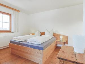 a bedroom with a bed with a wooden frame at Igl Hof Top 3 in Westendorf
