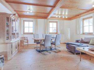 a living room with a table and a couch at Igl Hof Top 3 in Westendorf