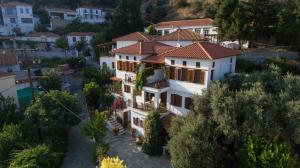 a large white house with a red roof at Traditional Mansion Kliaris in Ayía Kiriakí