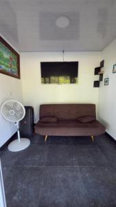 a living room with a couch and a window at One Piece in Golfito