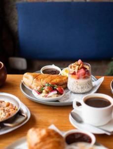 a table with plates of food and a cup of coffee at Hotel Mar Rey in Tamarindo