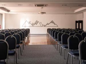 an empty room with chairs and a white wall at ibis Styles Bielsko Biala in Bielsko-Biała