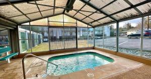 a large swimming pool in a building with windows at Riverfront Studio with Trail access in Bend