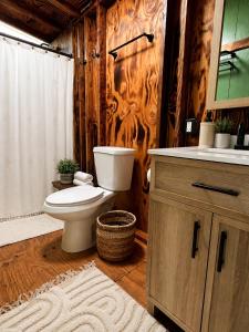 a bathroom with a toilet and a sink at JAWS Retreat Bungalow in Haleiwa