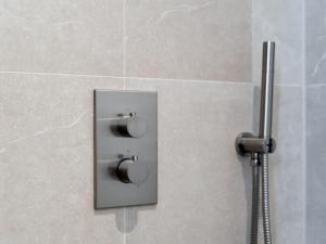 a control panel in a shower in a bathroom at Duinsuite in Oostkapelle