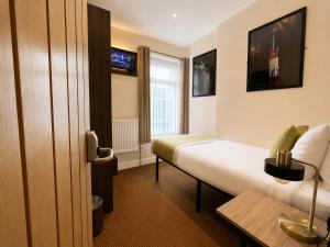 a hotel room with a bed and a window at The Kings Cross Hotel in Blackpool +43 photos