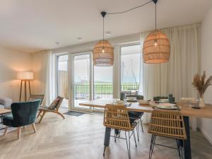 a living room with a dining room table and chairs at Zilte Haven in Kamperland