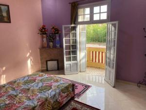a bedroom with a bed and an open door at Villa Sais avec piscine in Meknès +15 photos