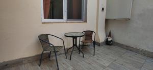 two chairs and a table in a room at Modest Ultra Central Apartment Council Square in Braşov