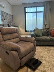 a living room with a couch and a couch and a living room at شقة الدانة وصول ذاتي القيصومه in Hafr Al-Batin